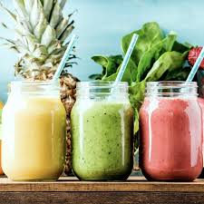 Jars of yummy smoothies all lined up with straws for snack time.