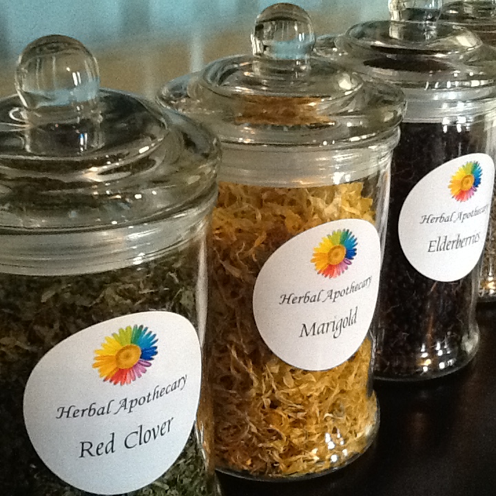 Three clear jars with all different herbs in them