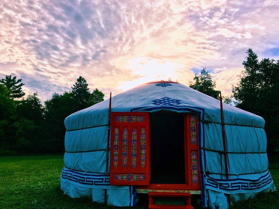 Yurt with a red door at sunrise